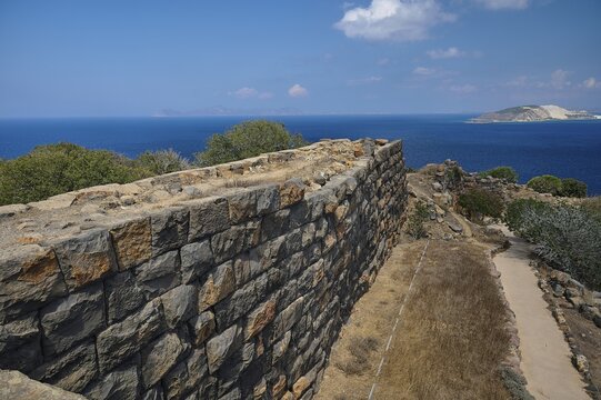 Ruin wall in an arid landscape with a view of the sea and a coastline in the background, Palaiokastro, Ancient fortress, 3rd and 4th century BC, above Mandraki, Nisyros, Dodecanese, Greek Islands, Greece