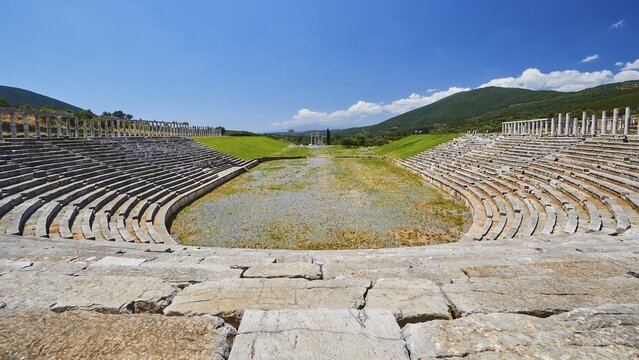 Empty ancient stadium with rows of seats in front of a hilly landscape, archaeological site, Ancient Messene, capital of Messinia, Messini, Peloponnese, Greece