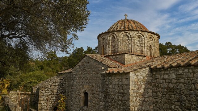 Stone and brick church with dome surrounded by trees and bright sky, sky exchanged, Thari Monastery, Moni Thari, near Gadouras Reservoir, lonely mountain region, Rhodes, Dodecanese, Greek Islands, Greece