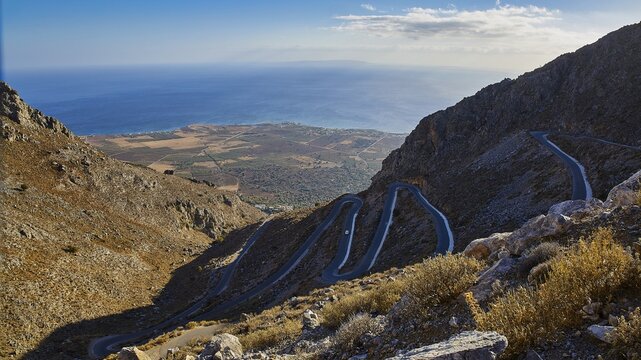 Serpentine road winds through a dry mountainous landscape down to the sea, Kallikratis, Kallikratis Gorge, Sfakia, West Crete, Crete, Greek Islands, Greece