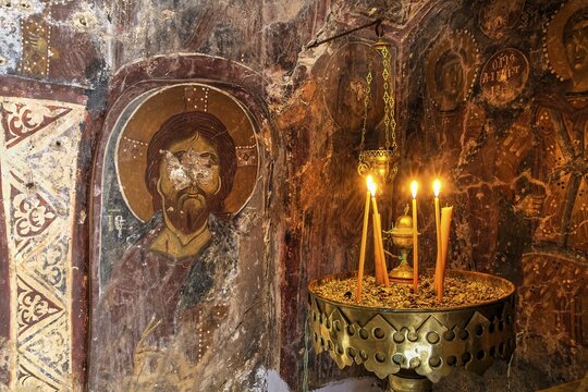 Candlelit orthodox wall painting in a dark, mystical setting, icon depicting Christ, church of Agia Anna, Lefka Ori, White Mountains, mountain massif, west, Crete, Greece