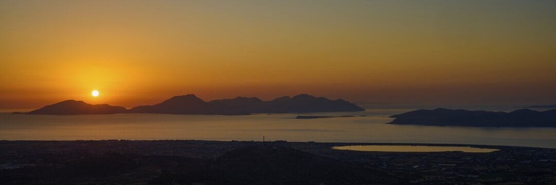 A striking sunset over the vast sea and several islands, salt lake, Tigaki, nature reserve, hydro biotope, Kos, Dodecanese, Greek Islands, Greece