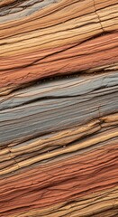 Fototapeta premium Vibrant close up of textured sedimentary rock layers in warm sandstone and terracotta tones