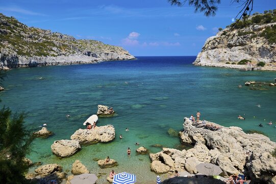 An idyllic bay with crystal-clear water, surrounded by rocks under a bright blue sky, Anthony Quinn Bay, Vagies Bay, Rhodes, Dodecanese, Greek Islands, Greece