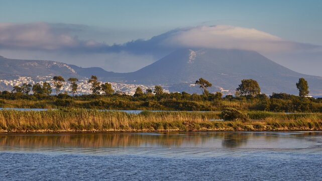 A mountain covered with clouds in the background, surrounded by water and trees, Gialova lagoon, protected wetland, bird paradise, Navarino Bay, Pylos, Peloponnese, Greece