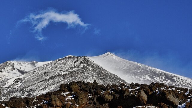 Snow-capped Etna peaks, clear view of a volcano with snow and distinctive rocks under a blue sky, UNESCO World Heritage Site Etna, volcano, volcanism, Sicily, Italy