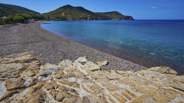 Beach with pebbles, mountains and clear blue water under a blue sky, Lambi beach, pebble beach, Patmos, Dodecanese, Greek Islands, Greece