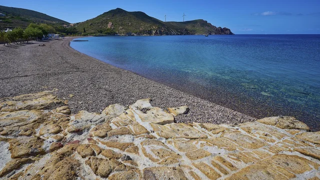 Beach with pebbles, mountains and clear blue water under a blue sky, Lambi beach, pebble beach, Patmos, Dodecanese, Greek Islands, Greece