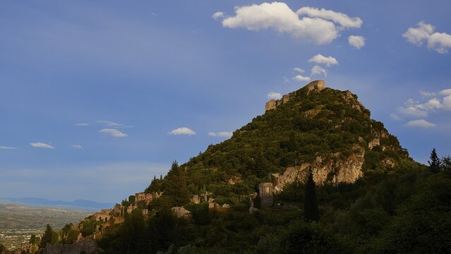 Natural scenery with ruins on a green mountain ridge under a slightly cloudy sky, Byzantine castle, Mystras, Mistra, UNESCO World Heritage Site, Medieval Byzantine ruined city, northwest of Sparta, foothills of the Tyagetos Mountains, Peloponnese, peninsula, Greece