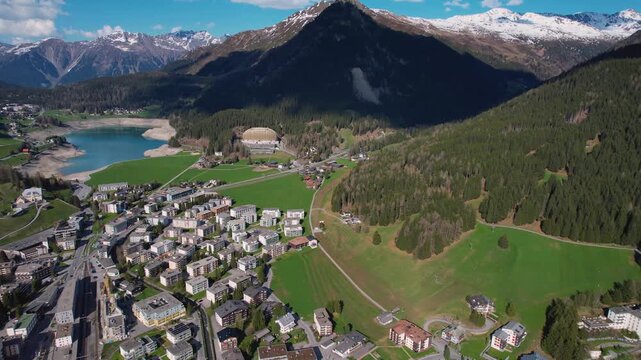 Aerial panoramic view above the downtown around the city Davos in Switzerland on a sunny summer afternoon. 