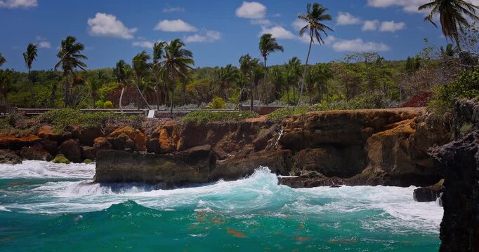 Ocean Waves Crashing Against Rocky Cliffs Along a Coastal Beach, Caribbean sea shoreline, Boca De Yuma, Dominican Republic aerial landscape
