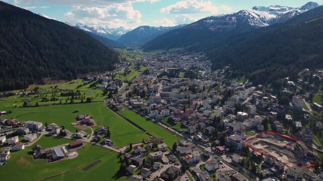 Aerial panoramic view above the downtown around the city Davos in Switzerland on a sunny summer afternoon. 