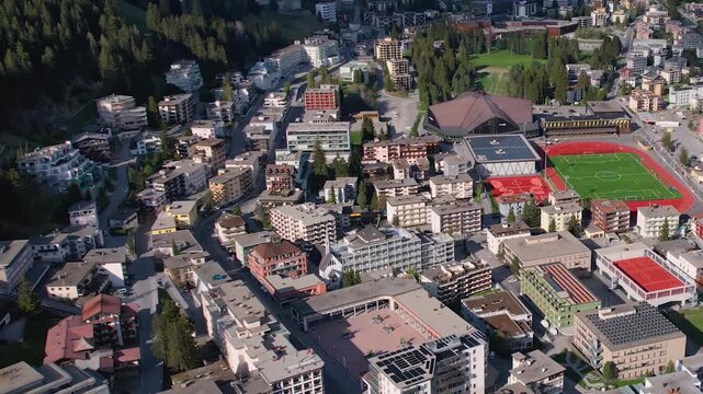 Aerial panoramic view above the downtown around the city Davos in Switzerland on a sunny summer afternoon. 