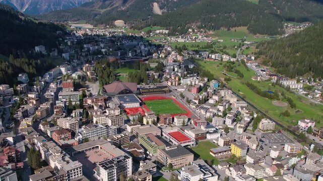 Aerial panoramic view above the downtown around the city Davos in Switzerland on a sunny summer afternoon. 