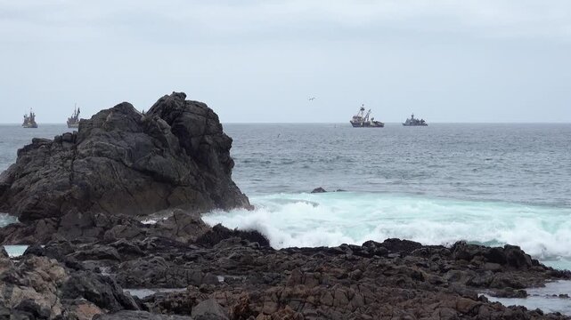 Pacific Ocean waves breaking against rocky shoreline on the coast of Ilo Peru