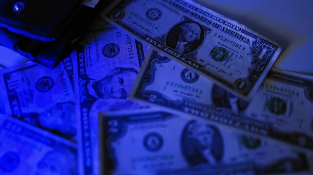 Police seized illegal money, smuggling. A close-up of the shadow market and dirty dollar bills used by criminals and scammers for laundering.