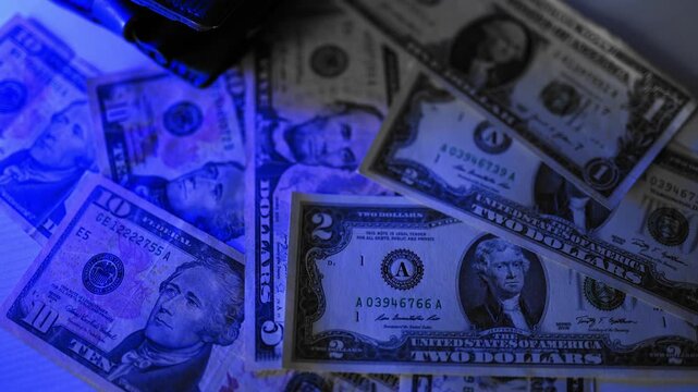 Police seized illegal money, smuggling. A close-up of the shadow market and dirty dollar bills used by criminals and scammers for laundering.