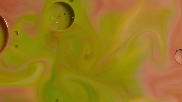 Abstract Fluid Art - Vibrant Green and Coral Paint Swirling with Glitter Macro