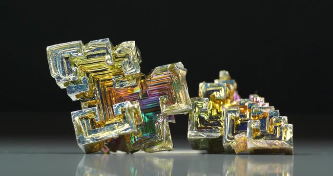 Bismuth crystals. Bismuth - chemical element with symbol Bi and atomic number 83. Post-transition metal and one of pnictogens. Synthesized bismuth crystal. Iridescent coloration is due to oxide film