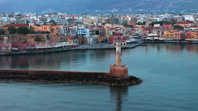  View of Chania with the amazing lighthouse, mosque, venetian shipyards, Crete, Greece.Waves crashing on lighthouse, Beautiful Greece and best scenic places - panorama