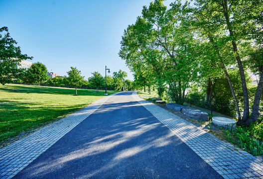 The paved pedestrian path running through Corning Preserve (aka Jennings Landing) along the Hudson River waterfront in Albany, New York