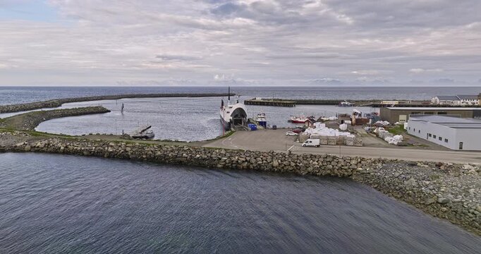 Andenes Norway Aerial v5 low level drone flyover water inlet capturing ferry and fishing boats docked at the harbor next to fish processing manufacturing facility - Shot with Mavic 3 Cine - June 2022