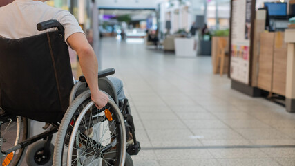 Obraz premium A Caucasian woman in a wheelchair shopping at a mall. 