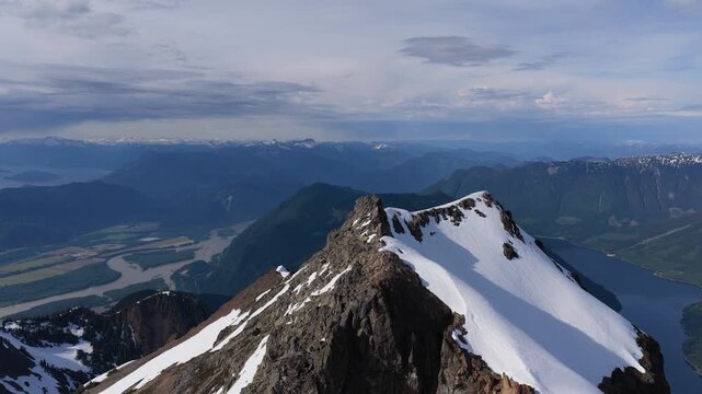 Stunning Aerial View of Snow-Capped Mountain Peaks, River, and Valley in British Columbia, Canada