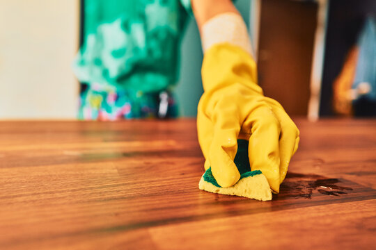Scrubbing a dirty spot off a hardwood table