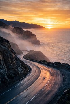 Winding coastal highway along steep cliffs at sunset with atmospheric mist and ocean views