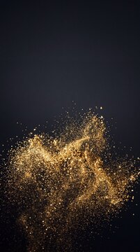 Golden glitter explosion with shimmering dust particles splashing against a dark charcoal background