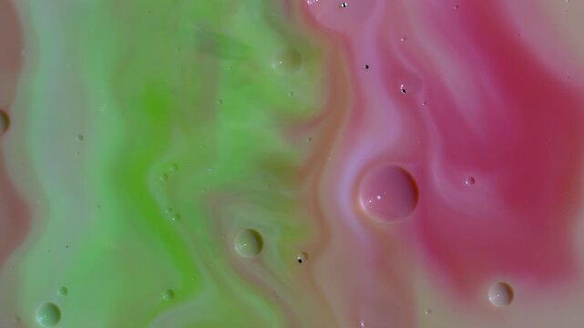 Abstract Fluid Art Macro - Swirling Lime Green and Pink Paint Waves with Oil Bubbles