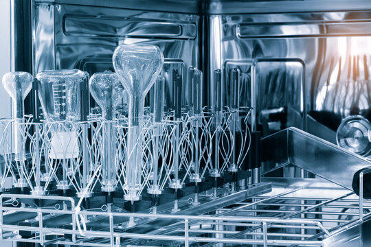 Laboratory chemical glass after washing in a special washing machine with the door open.
