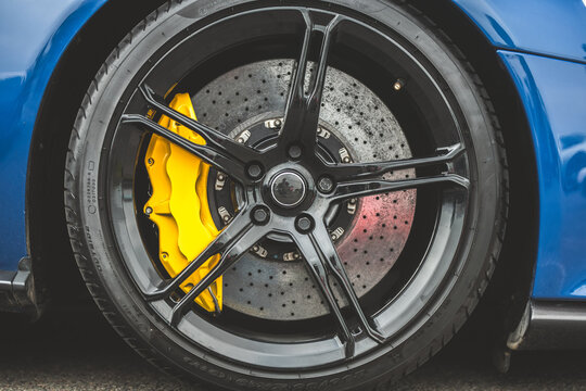 Close-up of a high-performance car wheel with bright yellow brake calipers