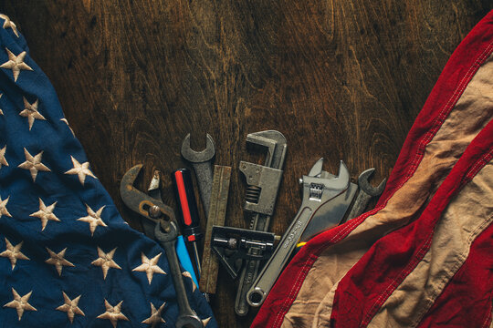 Collection of worn work tools with the American flag. Symbolic of blue collar workers, USA manufacturing, pride in products Made in United States of America, or for Father's day or US Labor Day.