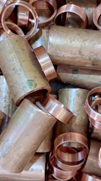 Thick copper tube offcuts left over from an industrial plumbing installation to be recycled