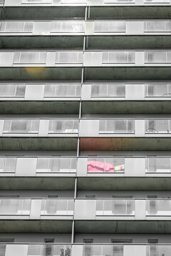 Sunlit modern residential balconies forming abstract urban architectural pattern.