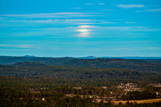 Moon among the clouds over a forest during the blue hour, in Mexiquillo Durango, Sierra Madre Occidental Mexico