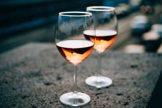 Glasses of rose wine in summer sunshine during a outdoors party or a picnic.
