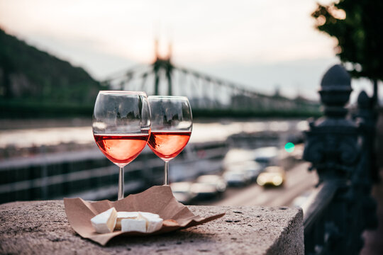 Glasses of rose wine in summer sunshine during a outdoors party or a picnic.