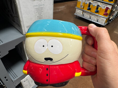 Mesa, Arizona - June 28, 2026: Hand holds an Eric Cartman South Park character coffee mug for sale