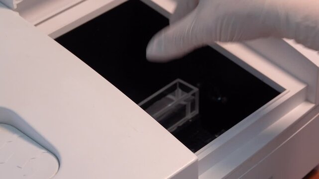 Close-up footage of a laboratory experiment with test tubes and glassware, featuring bubbling and mixing liquids. Scientific research process in a modern lab environment, showcasing chemical reactions