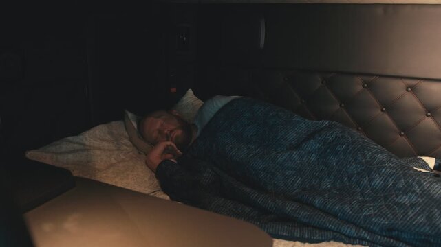 Truck driver waking up in his sleeper cab berth