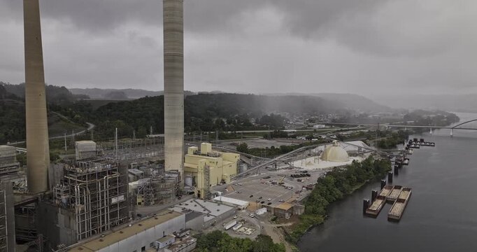 Brilliant Ohio Aerial v9 flyover a large industrial facility, a power plant with towering smokestacks, situated alongside a river under an overcast sky - Shot with Mavic 3 Pro Cine - Sept 24th 2023