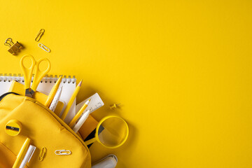 Naklejka premium Back to school flat lay with yellow stationery, backpack and supplies on bright banner background
