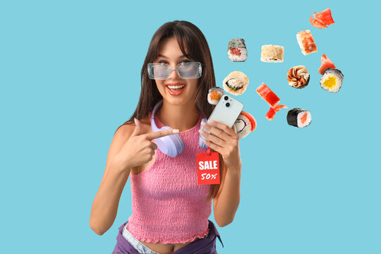 Young woman holding smartphone with sushi pieces floating