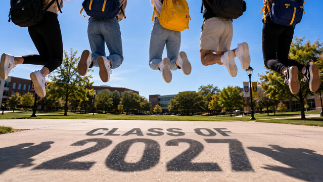 Group of students jumping with "CLASS OF 2027" inscription on the ground