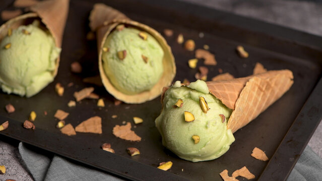 Pistachio Ice Cream Scoops in Crispy Waffle Cones