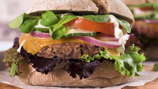 Gourmet black bean burger with fresh vegetables on a toasted bun