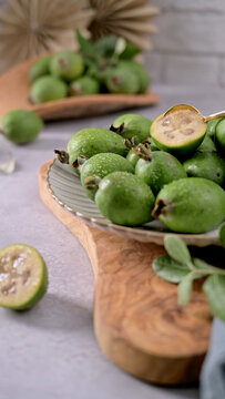 Fresh Feijoa Fruits Served on a Plate with a Golden Spoon